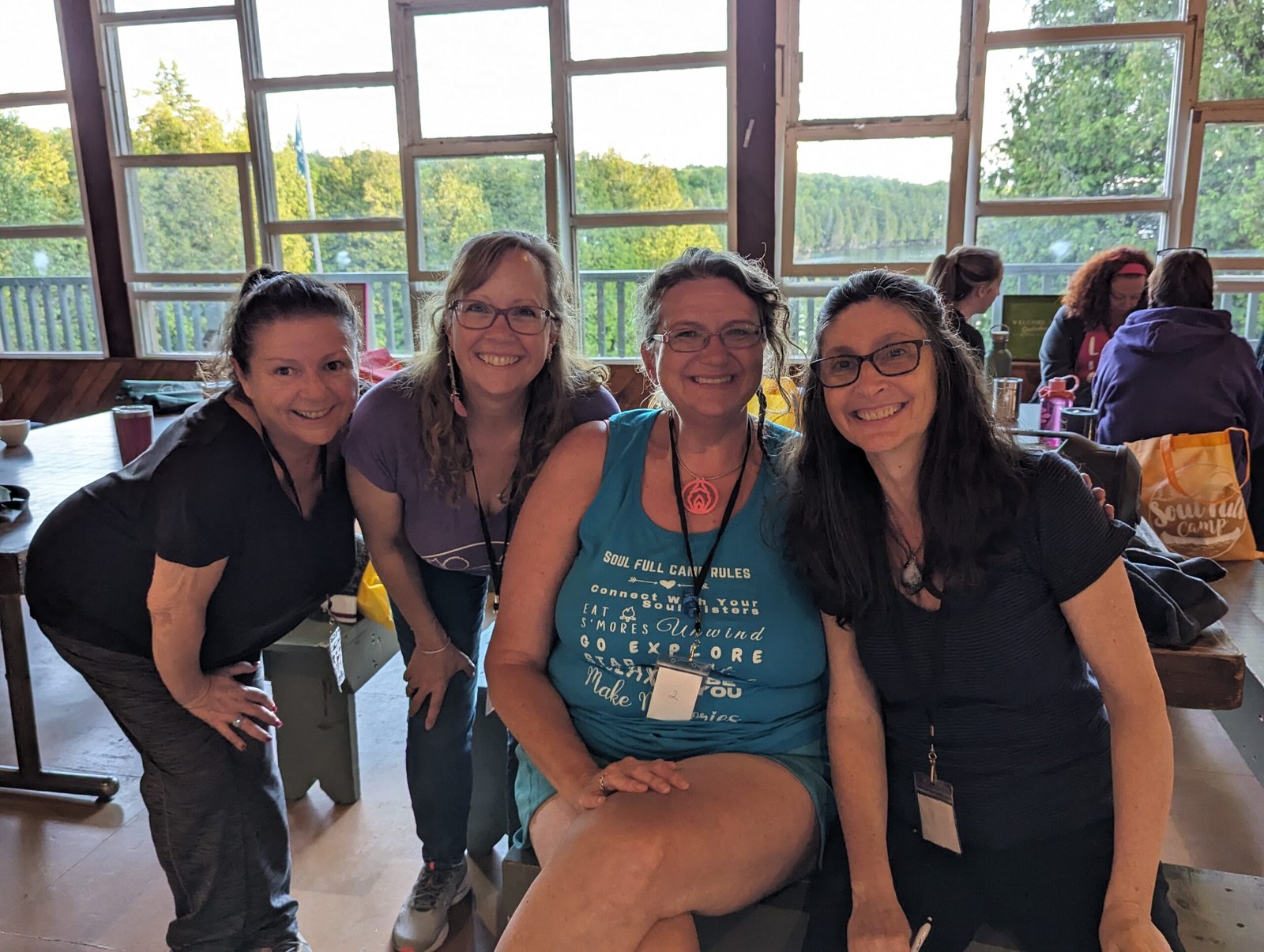 Four women smiling together at a Soul Full Camp women's retreat in Ontario, Canada