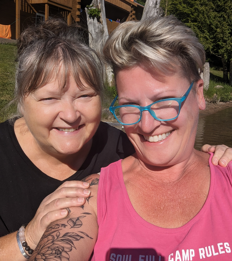 Heather and Jenny, co-founders of Soul Full Events, smiling lakeside at a women's wellness camp in Ontario